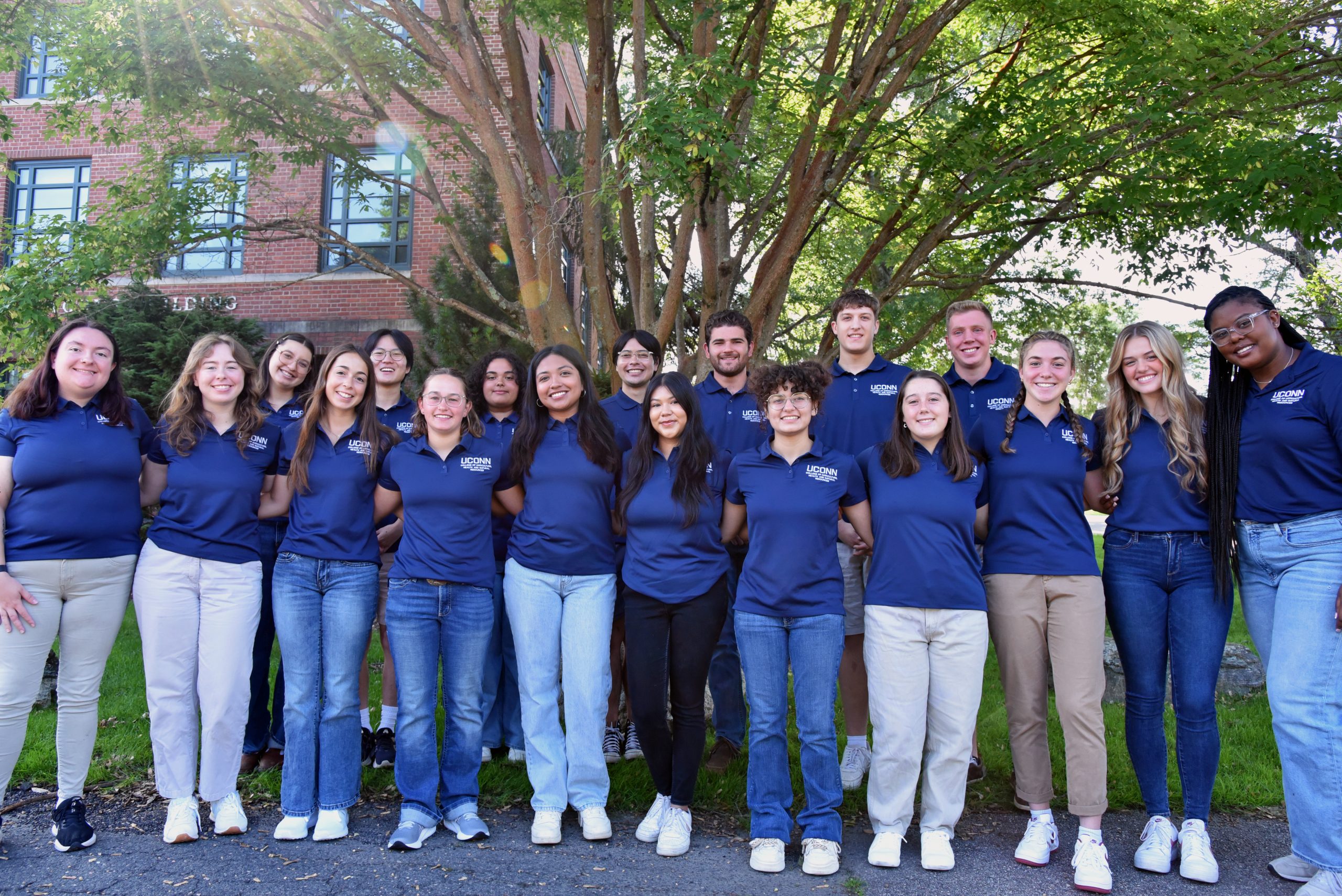 Group of students standing outside an academic building.