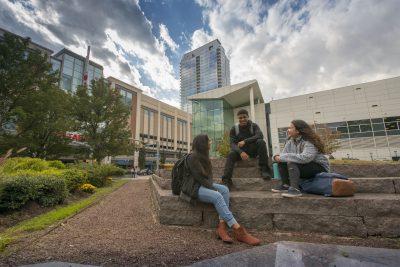 Students socializing outside in a park at Uconn Stamford on Oct. 17, 2018. (Sean Flynn/UConn Photo)