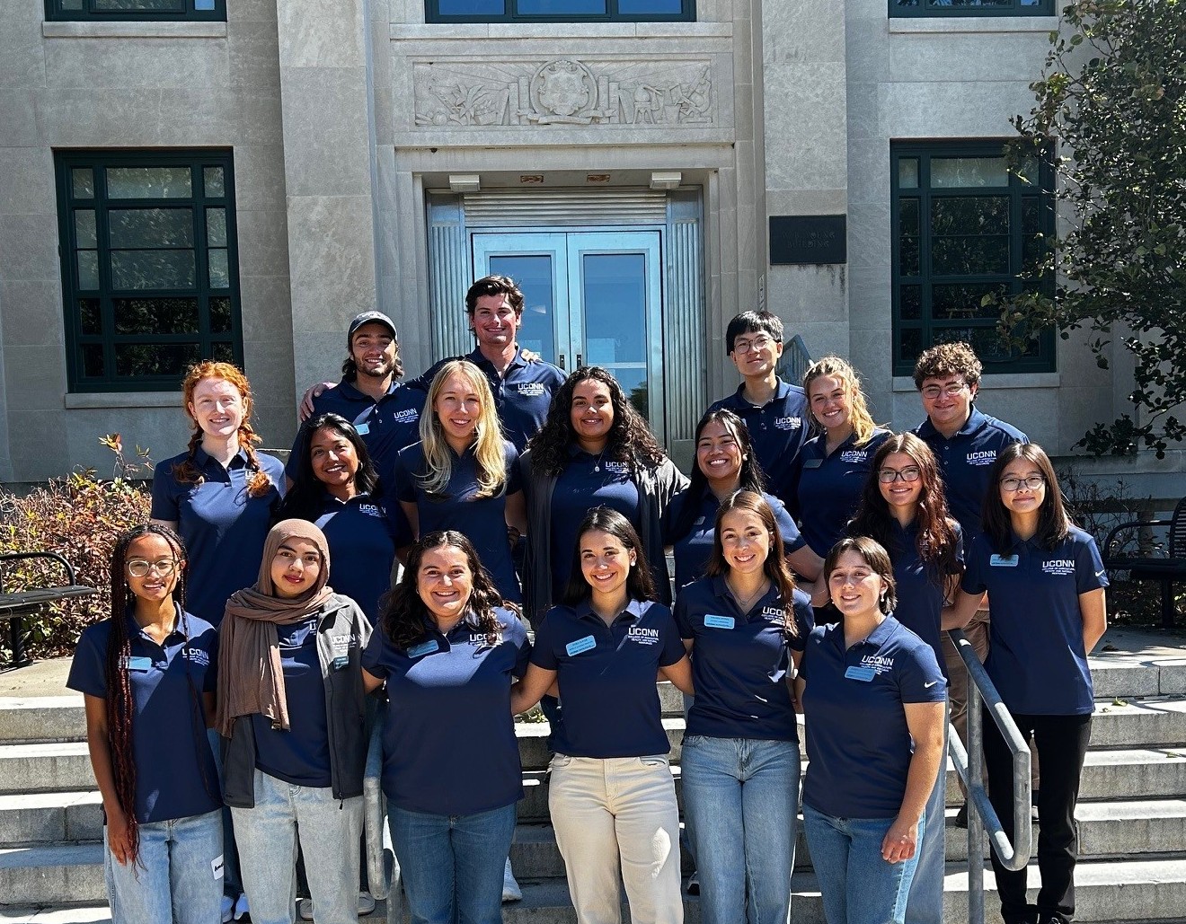 Group of students standing outside an academic building.