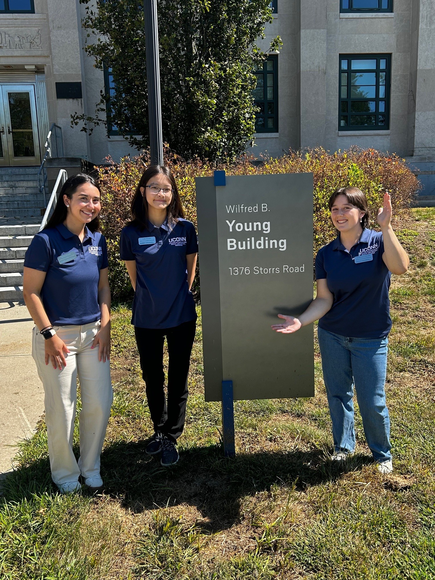 CAHNR Ambassadors pose in front of Wilfred B. Young sign